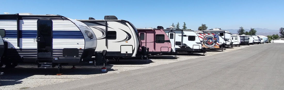Large RVs and trailers parked on paved stalls with easy maneuvering space