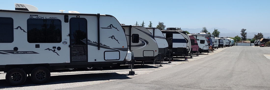 Secure gated RV and boat storage facility with 24/7 keypad access and surveillance cameras